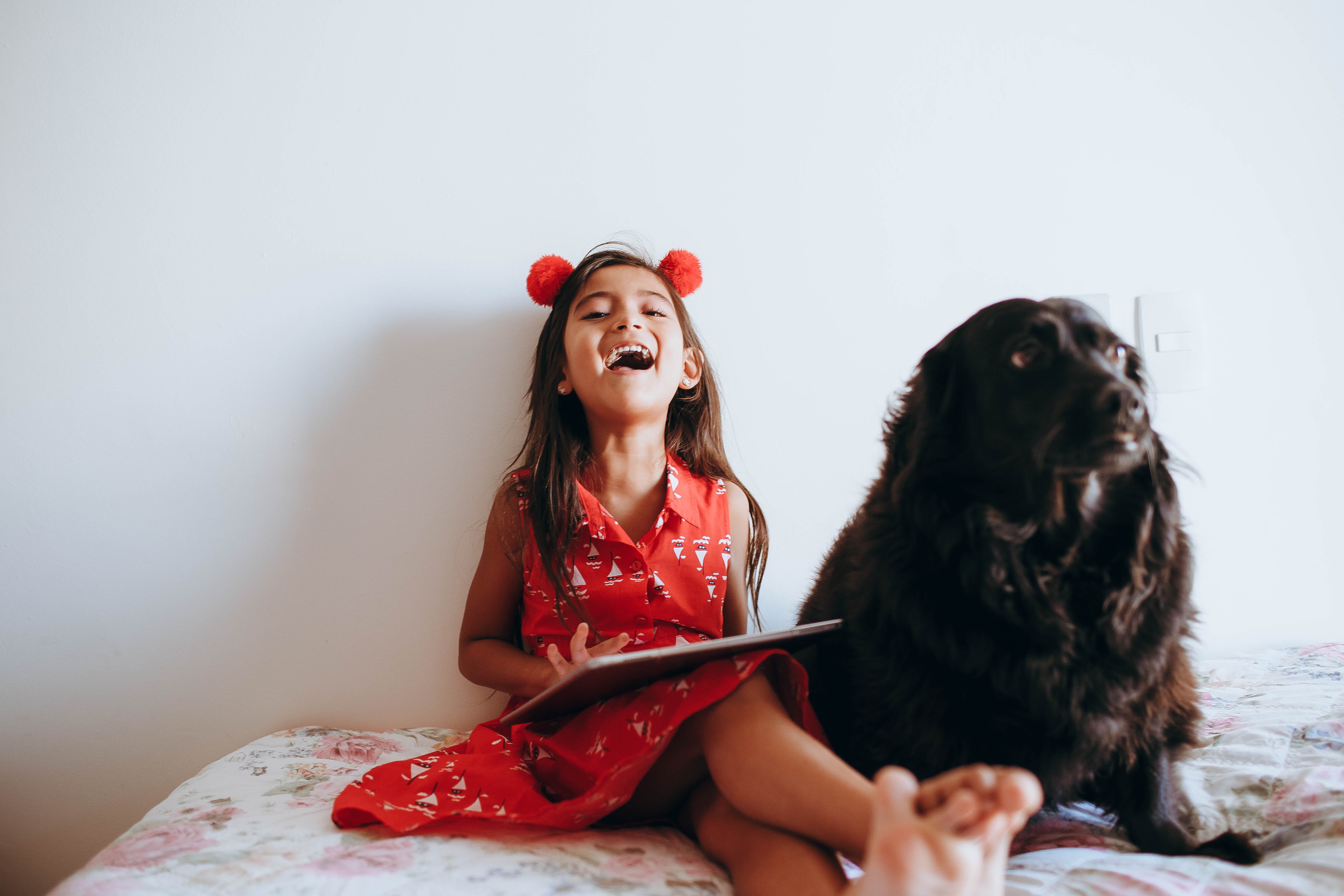 girl laughing with her dog